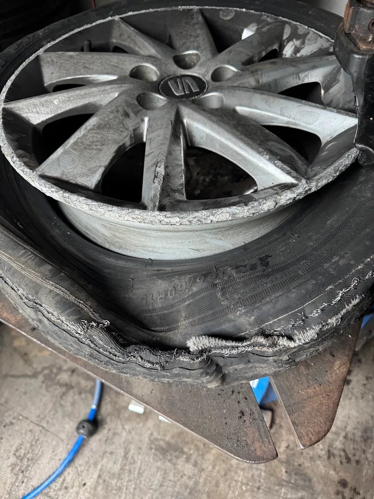 Mobile tyre fitting van with technician working on vehicle