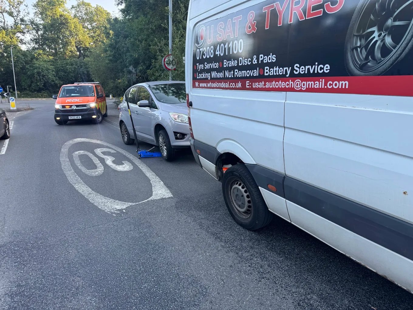 Mobile tyre fitting van with technician working on vehicle